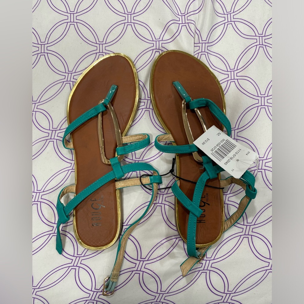 Teal sandals with gold accents.
